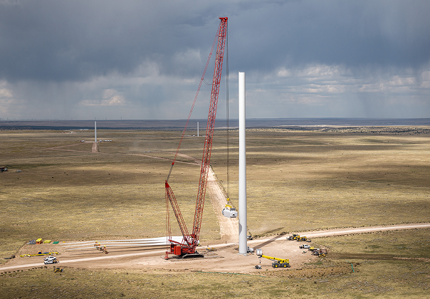 A crane assembling a wind turbine